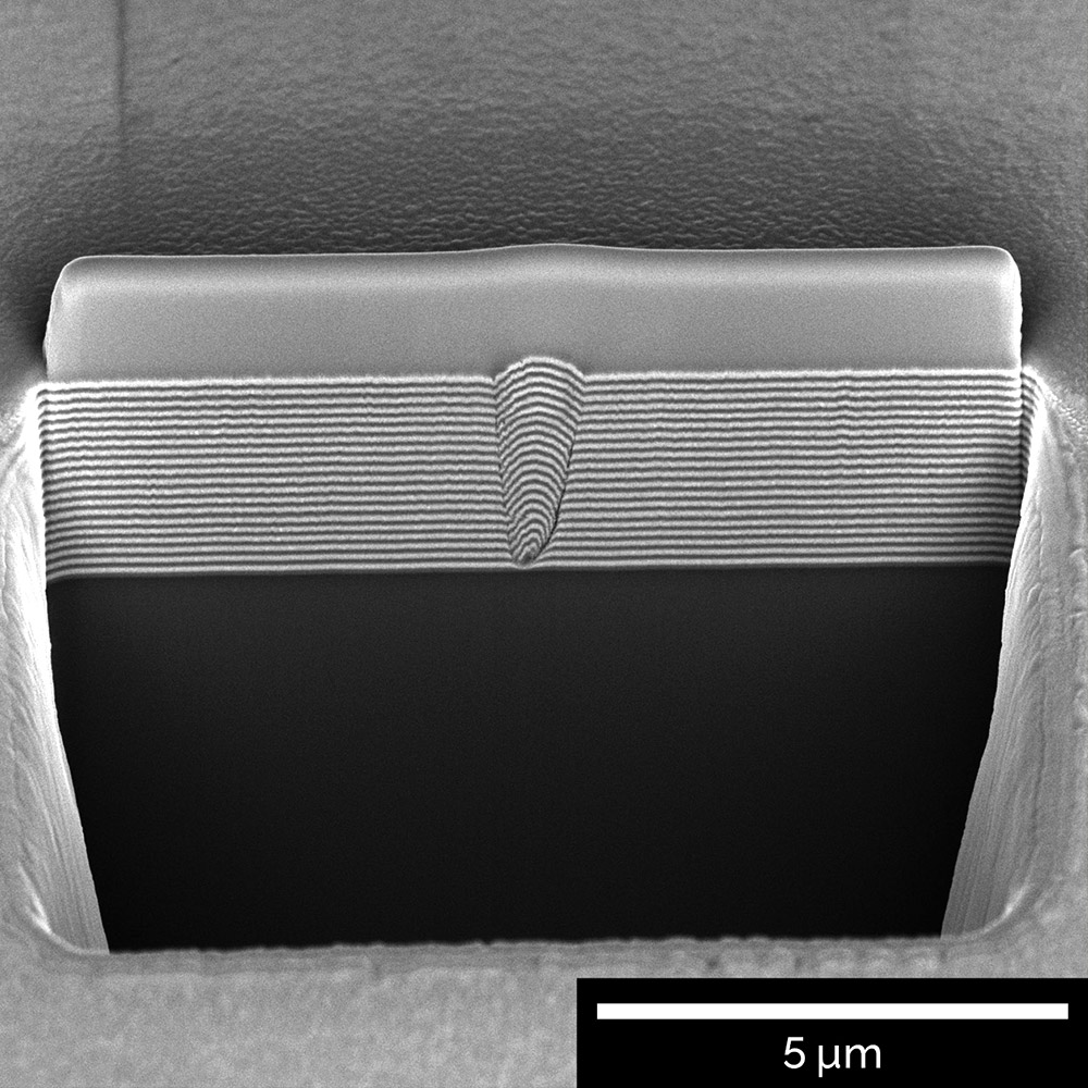 A cross section through a defect in a multi-layered coating